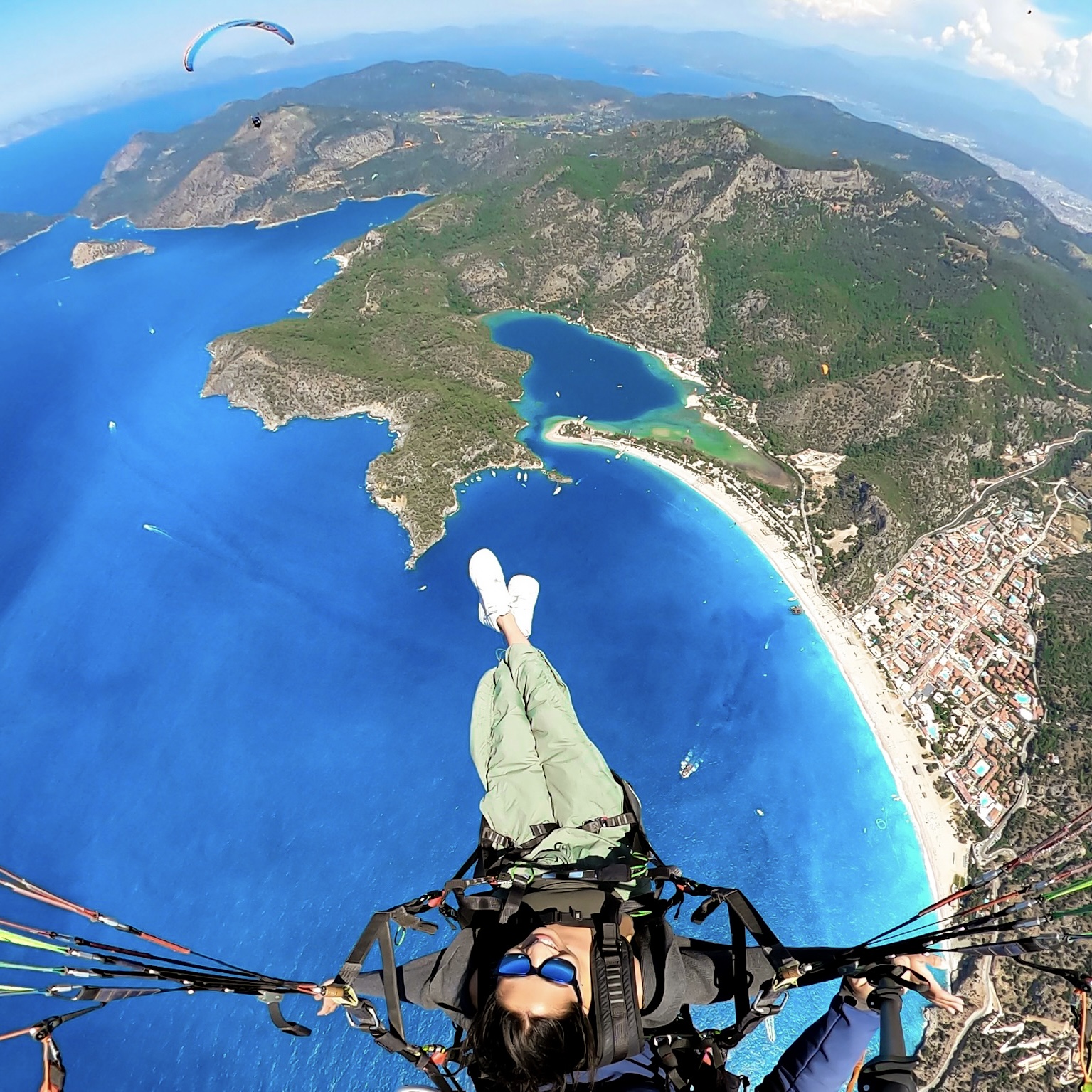 Paragliding over coastal bay